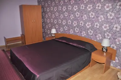 a bedroom with a bed with a purple bedspread at Guest rooms Sveti Nikola in Pomorie