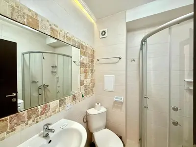 a bathroom with a toilet and a sink and a shower at Menada Apartments in Cascadas in Sunny Beach