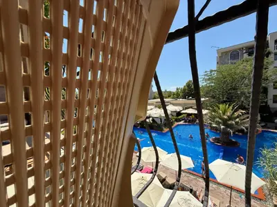 a view of the pool from the balcony of a hotel at Menada Apartments in Cascadas in Sunny Beach