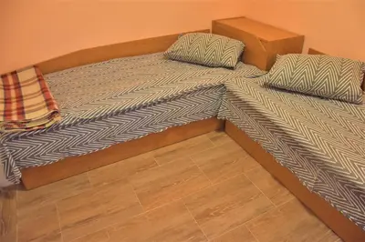 a bed with two pillows on it in a room at Bungalows Dani in Kamchia