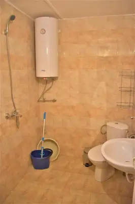 a bathroom with a toilet and a sink at Bungalows Dani in Kamchia