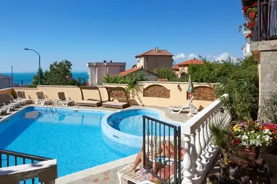 a large swimming pool with avisorvisorvisorvisor at Family Hotel Milev in Sveti Vlas