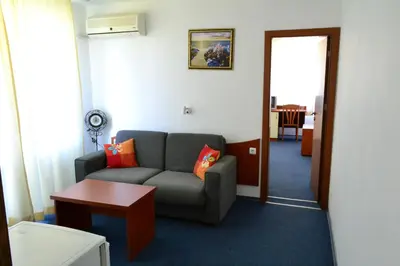 a living room with a couch and a table at Saint George Family Hotel in Lozenets
