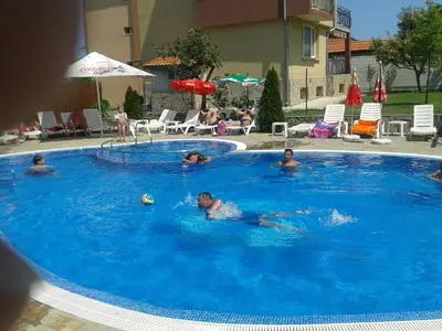 a group of people swimming in a swimming pool at Saint George Family Hotel in Lozenets