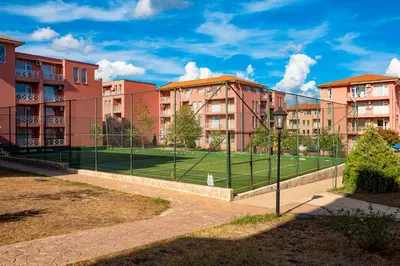 a tennis court in front of some buildings at Sunny Day 6 - Menada Apartments in Sunny Beach