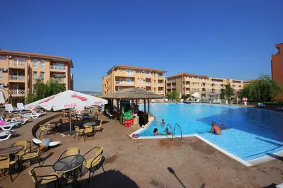 a swimming pool with chairs and people in a resort at Sunny Day 6 - Menada Apartments in Sunny Beach