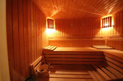 a large wooden sauna with a bench in it at Menada Apartments in Karolina in Sunny Beach