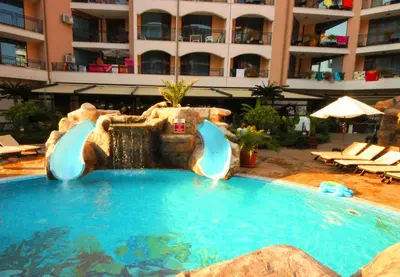 a swimming pool with a water fountain in a hotel at Menada Apartments in Karolina in Sunny Beach