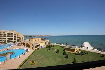 a view of a resort with a pool and the ocean at Menada Grand Resort Apartments in Aheloy