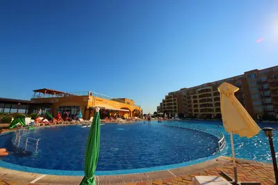 a large swimming pool with umbrellas in a resort at Menada Grand Resort Apartments in Aheloy
