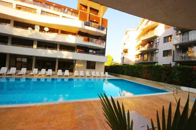 a swimming pool in front of a building at Eden - Menada Apartments in Sunny Beach