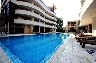a large swimming pool in front of a building at Eden - Menada Apartments in Sunny Beach