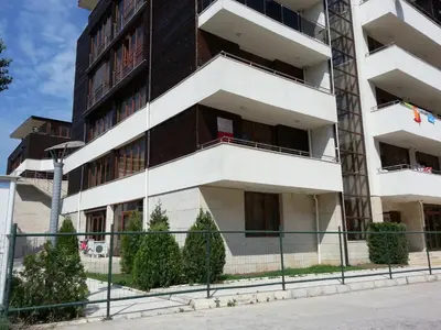 an apartment building with balconies and a fence at Eden - Menada Apartments in Sunny Beach