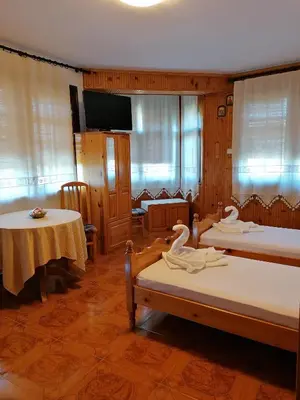 two beds in a room with two swans on them at Апартамент КИМАКО 2, 100м2 на цена за хотелска стая за двама in Tsarevo