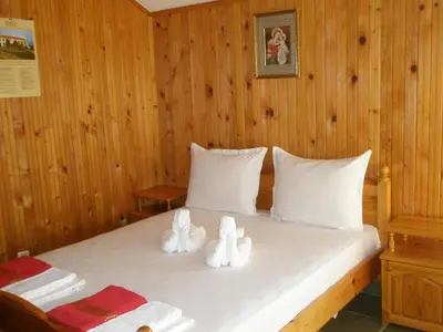 a bedroom with a bed with white towels on it at Апартамент КИМАКО 2, 100м2 на цена за хотелска стая за двама in Tsarevo