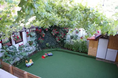 a miniature garden with two children playing on a artificial lawn at Апартамент КИМАКО 2, 100м2 на цена за хотелска стая за двама in Tsarevo