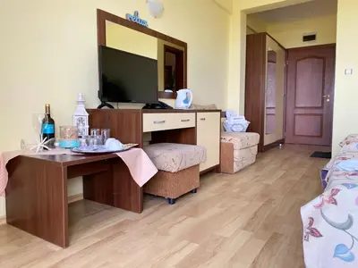 a room with a desk and a television in a room at Hotel Zaara in Sunny Beach