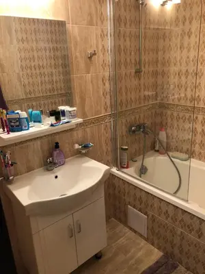 a bathroom with a sink and a shower and a tub at Amazing apartment facing the sea in Burgas City