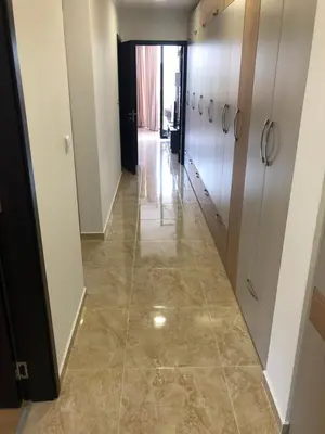 a corridor in a building with a tile floor at Amazing apartment facing the sea in Burgas City
