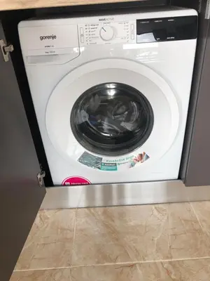 a washing machine with its door open in a kitchen at Amazing apartment facing the sea in Burgas City