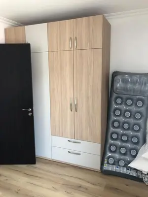 a room with wooden cabinets and a black door at Amazing apartment facing the sea in Burgas City