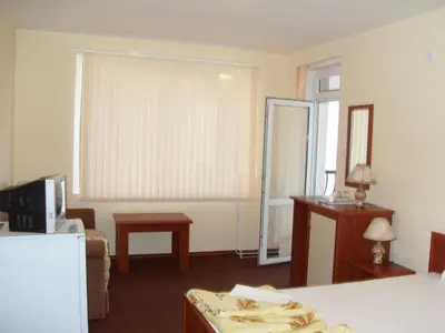 a room with a bed and a window with a mirror at Kirovi House - guest rooms in Tsarevo