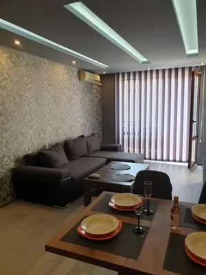 a living room with a couch and a table at MitProt Panorama Bay 2 luks apartment 102 in Sveti Vlas