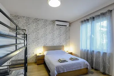 a bedroom with a bed and a window and a ladder at Studio Thermi 1 in Varna City