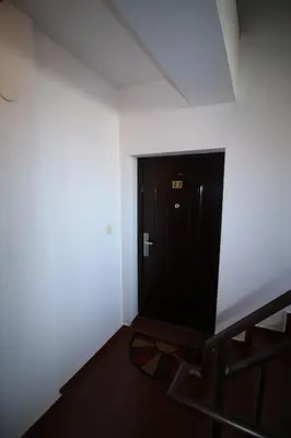 a room with a black door in a white wall at SEA PANORAMA appartment in Varna City