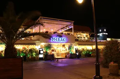 a night view of a restaurant with a lit up sign at SEA PANORAMA appartment in Varna City