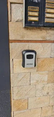 a television sitting on the side of a brick wall at SEA PANORAMA appartment in Varna City