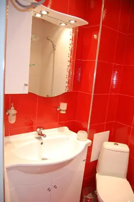 a red bathroom with a sink and a toilet at SEA PANORAMA appartment in Varna City