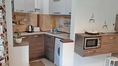 a small kitchen with a sink and a microwave at 500 steps to the sand in Varna City