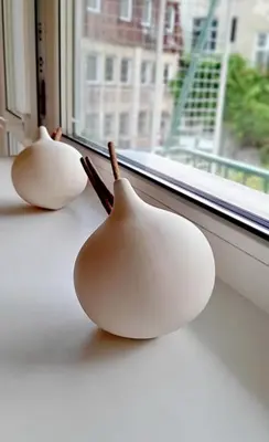 two white ceramic birds sitting on a window sill at 500 steps to the sand in Varna City