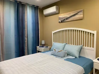 a bedroom with a large bed with blue pillows at PARADISO 308-309 Private Studios Nessebar in Nesebar