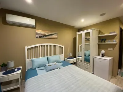 a bedroom with a bed with blue pillows at PARADISO 308-309 Private Studios Nessebar in Nesebar