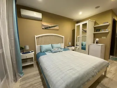 a bedroom with a large bed with blue sheets at PARADISO 308-309 Private Studios Nessebar in Nesebar