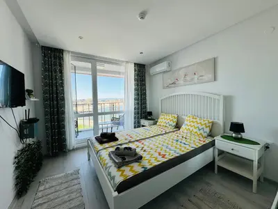 a bedroom with a bed and a window at PARADISO 308-309 Private Studios Nessebar in Nesebar