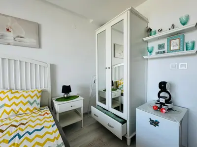 a small bedroom with a bed and a mirror at PARADISO 308-309 Private Studios Nessebar in Nesebar