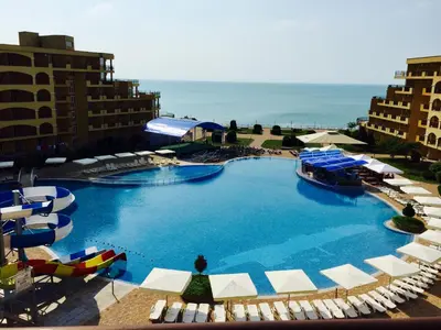 a large swimming pool with chairs and umbrellas at PSB Apartments in Midia Resort Aheloy in Aheloy