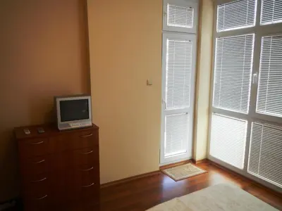 a bedroom with a tv on a dresser and a window at Apartment in Elit 3 Apartcomplex in Sunny Beach