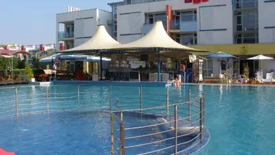 a swimming pool with a boat in the water at Apartment in Elit 3 Apartcomplex in Sunny Beach