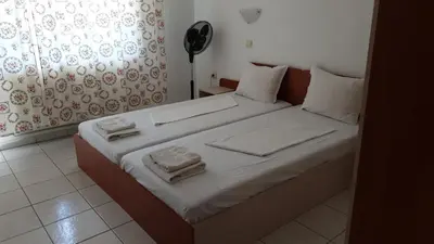 a bedroom with a bed with towels on it at Майстор Костадин - 1878 in Obzor