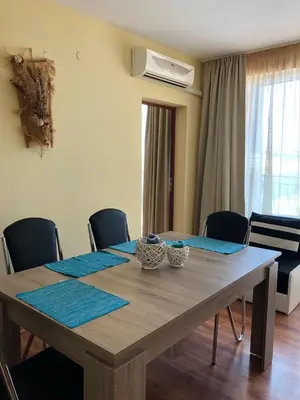 a dining room table with blue mats on it at Family Hotel Littoral in Sozopol