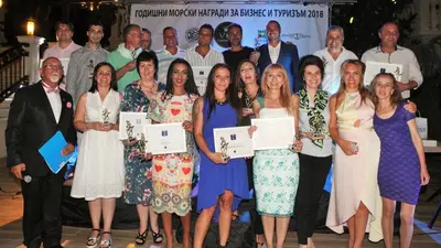 a group of people posing for a picture with certificates at Ribarska Sreshta Family Hotel in Tsarevo