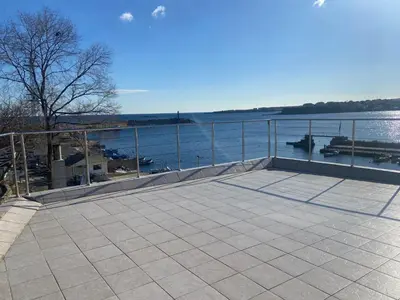 a large patio with a view of the water at Ribarska Sreshta Family Hotel in Tsarevo