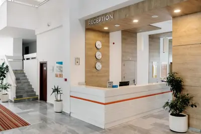 a reception area of a hospital with clocks on the wall at AluaSun Helios Beach - All Inclusive in Obzor