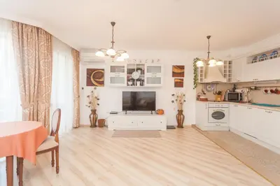 a large living room with a table and a television at Dom-El Real Apartments Amphora in Sveti Vlas