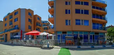 a tall building with umbrellas in front of it at Dara Hotel in Primorsko