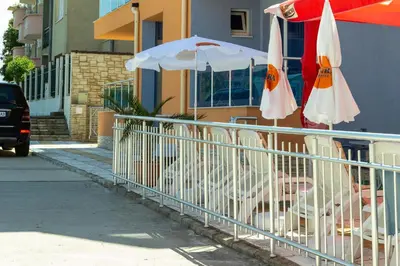 a fence with an umbrella next to a building at Dara Hotel in Primorsko